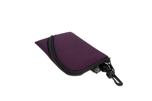 A Mini Ghost Whale Pouch in Aubergine (dark purple).